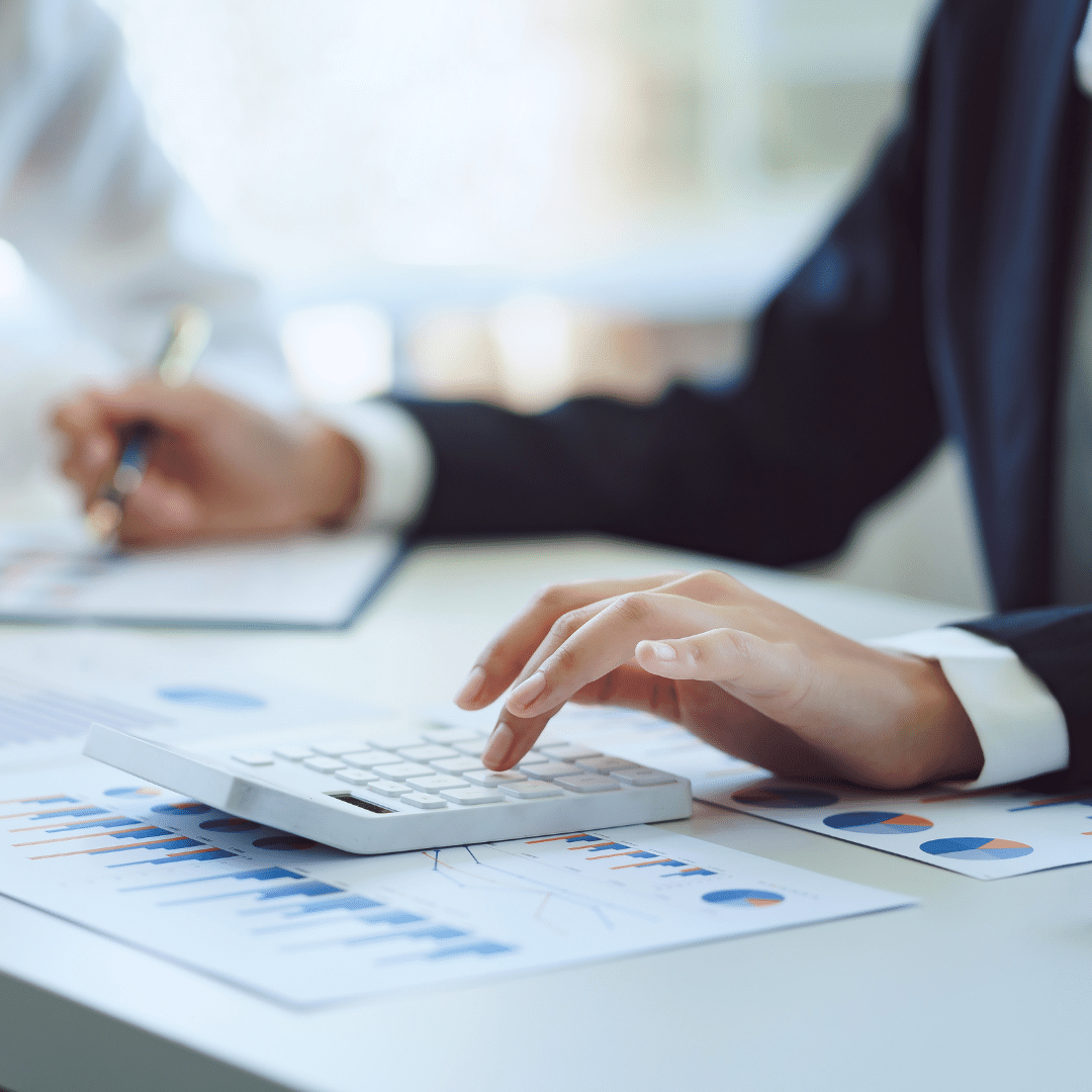 Businesswoman is reading information of new business project and taking notes in document while thoughtful about accounting of business and working on laptop at modern office.