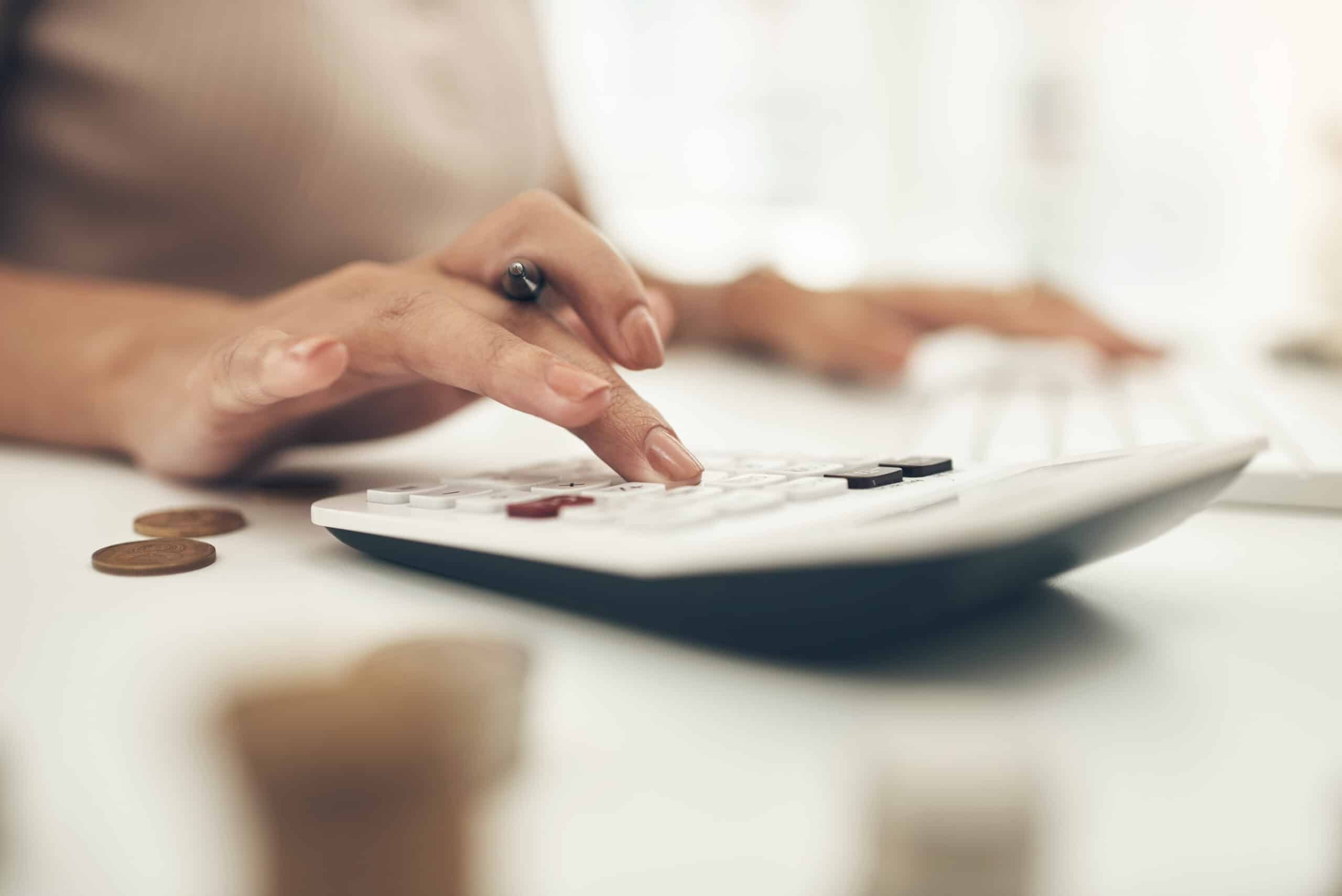 Closeup shot of an unrecognisable businesswoman calculating finances in an office.