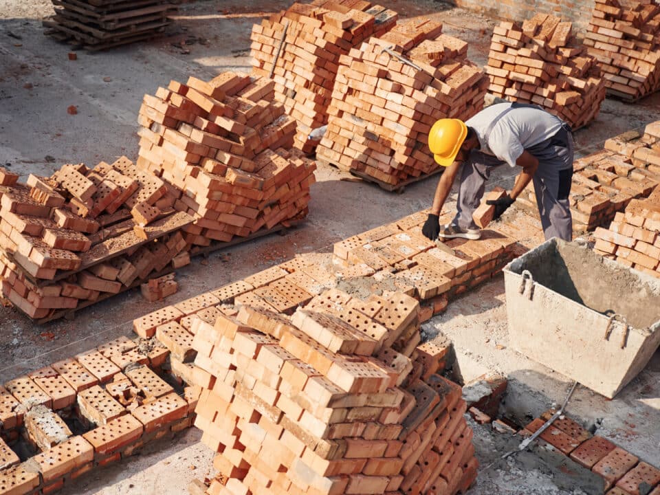 Top view. Handsome Indian man is on the construction site.